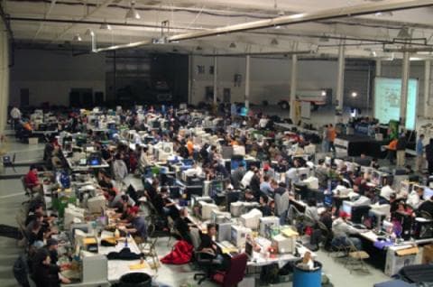 Rows of CRT monitors and packed tables at the early GXL 256-man LAN